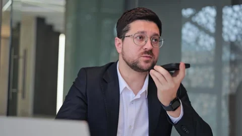 Focused Professional Records Voice Message in Office Stock Footage 330097284