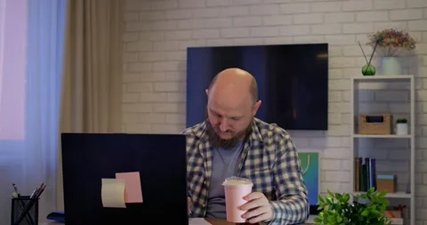 Focused professional taking coffee break, sipping beverage while browsing laptop Stock Footage 301524318