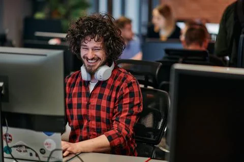Focused Programmer With Afro Hairstyle in Plaid Shirt Working on Computer in 写真素材