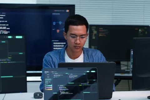 Focused Programmer Developing Digital Solutions with Code Stock Photos