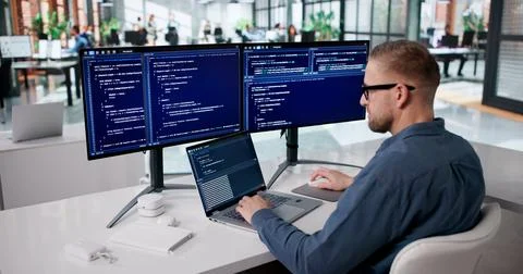 Focused Programmer Developing Innovative Software At His Workspace Stock-Fotos