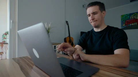 Focused programmer develops new game on laptop at home Stock Footage 228922386