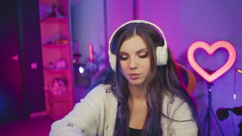 Focused programmer on headphone working in vibrant studio environment Stock Footage 307459804