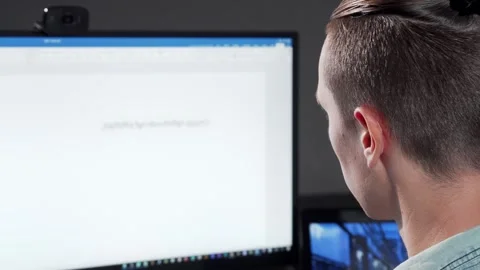 Focused programmer immersed in late-night coding session Stock Footage 311893074