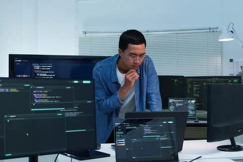 Focused Programmer Reviewing Digital Code and AI Development Stock Photos