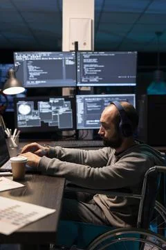 Focused Programmer in Wheelchair Working at Multi Screen Setup Stock-Fotos