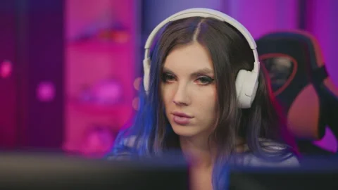 Focused Programmer Working with Headphones in Colorful Workspace Stock Footage 307459043