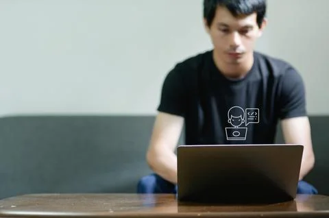Focused Programmer Working on Laptop in Modern Workspace Environment Stock Photos