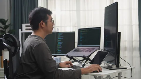 Focused Programmer Working on Multiple Screens in a Remote Office Setup to .. Stock-Footage 336680532