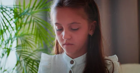 Focused school-age girl learning basic chords on electronic piano Video stock 313293383