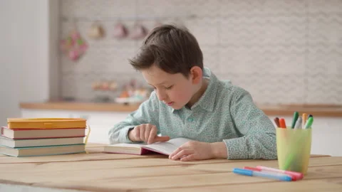 Focused school boy studying with books at home, cute smart little schoolboy Stock Footage 154259838