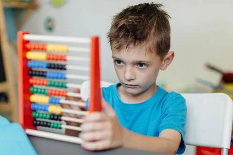 Focused schoolboy learning maths with an abacus Stock Photos