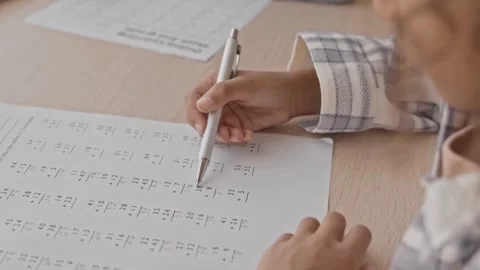Focused Schoolgirl Solving Math Problems at Her Desk in Slow Motion Stock Footage 321985267
