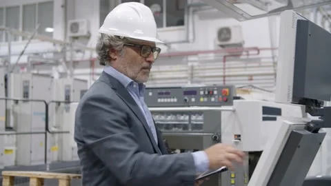 Focused senior engineer testing industrial machine Video stock 147500440