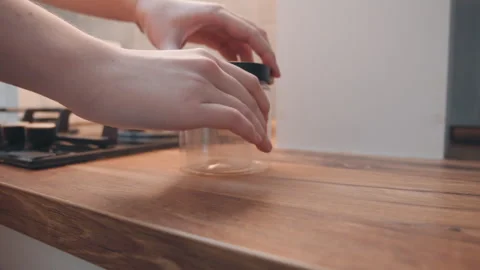 Focused shot of kitchen routine with spice container and stove. Arranged spices Stock Footage 337466885