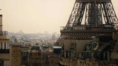 Focused shot of the lower part of the Eiffel Tower surrounded by buildings Stock Footage 241197468
