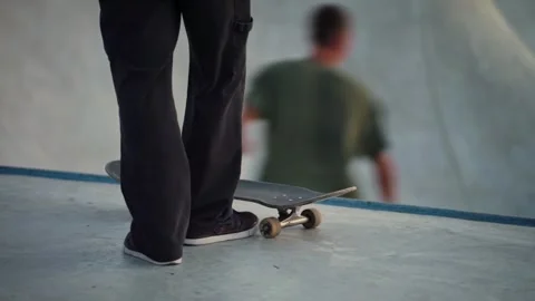 Focused Skateboarder Preparing for Challenging Maneuver in Urban Skatepark Stock Footage 340483242