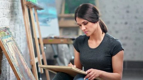 Focused skilled female painter making sketching using pencil working at art Видео 109043132