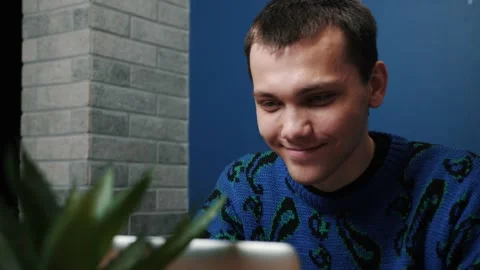 Focused smiling caucasian man work and typing on a laptop. Young male Stock Footage 144492460
