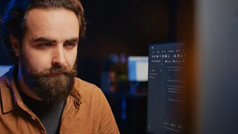 Focused software developer in home office doing coding on computer, close up 스톡 사진