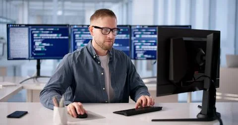 Focused Software Developer Programming At Office Desk 스톡 사진