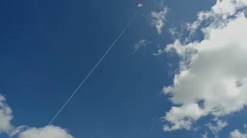 Focused on the strings crisp detail as a kite flies high against soft, clouded Video stock 310314643