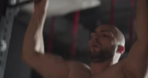 Focused strong sportsman doing pull ups during workout Stock Footage 172328079