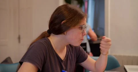 Focused Student at Her Desk: Stock Footage 334776531