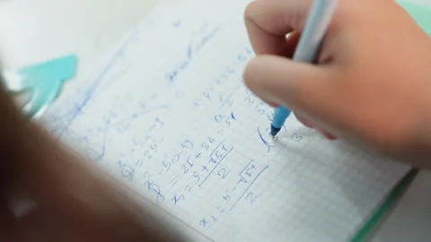 Focused student hurriedly writes formulas in notebook. Diligent learner quickly Video stock 328147390