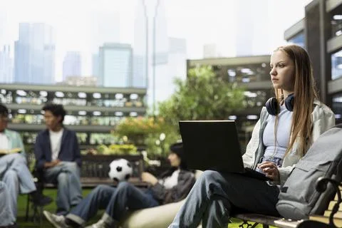 Focused student pauses taking notes and thinking about ideas Stock Photos