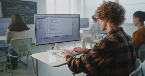 Focused Student Types Computer Code Quickly on Keyboard Stock Footage 318526485