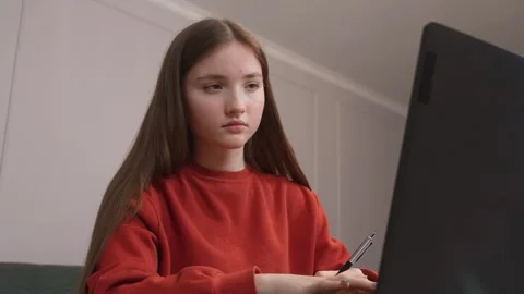 Focused student typing on laptop, studying at home Stock Footage 311780068