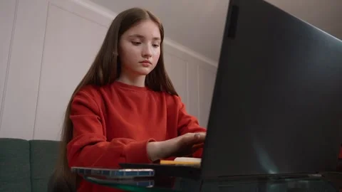 Focused student typing on laptop, studying at home Stock Footage 311780767