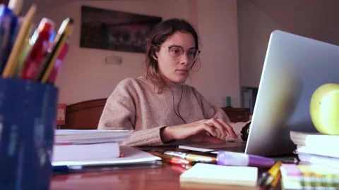 Focused student using a laptop on her bedroom. Stock Footage 145811402