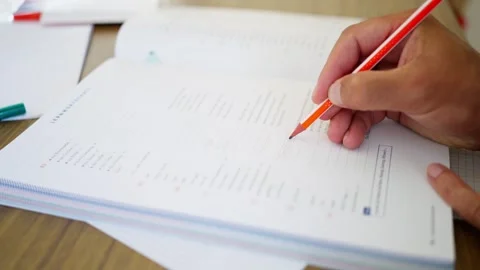 Focused student writes detailed notes in a wellorganized notebook Stock Footage 282907969