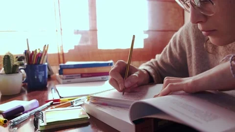 Focused student writing notes on a notebook. Stock Footage 145811392