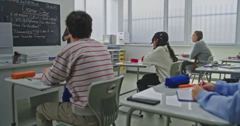 Focused Students Listen to Teacher Explaining Coding Assignment Stock Footage 320998959