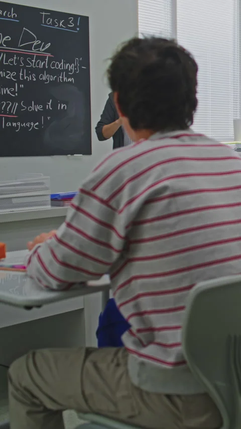 Focused Students Listen to Teacher Explaining Coding Assignment Video stock 320999847