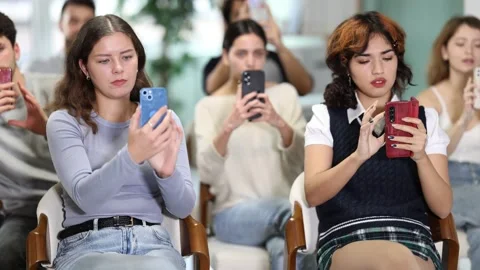 Focused students using mobile phones to scan QR code during an interactive class Stock Footage 330415692