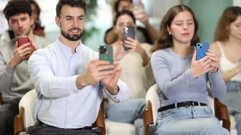 Focused students using mobile phones to scan QR code during an interactive class Stock Footage 341426977