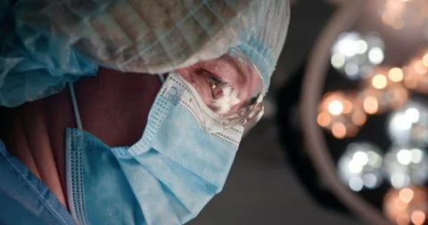 Focused surgeon in operating room during a complex medical procedure Stock Footage 302715624