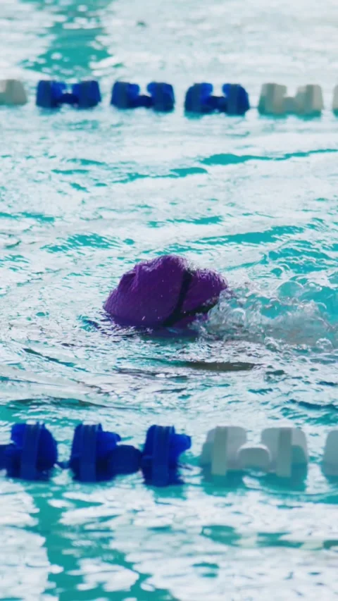 Focused swimmer moves through clear blue water Stock Footage 346458584