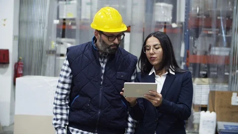 Focused technician and project manager walking with tablet Stock Footage 127345419