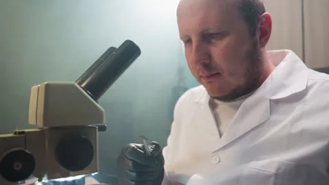Focused Technician Examining Electronic Component Under Microscope Video stock 284360158