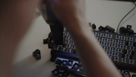 Focused technician using small vacuum cleaner to remove dust and debris from Stock Footage 342766766