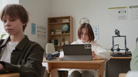 Focused Teenagers Using Laptops and Digital Tablet to Study During Class Stock Footage 335691018