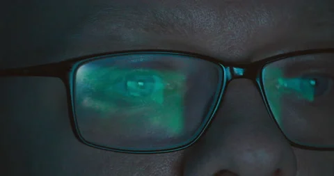 Focused trader wearing eyeglasses looking at laptop screen reflecting in glasses Vídeos de archivo 239520174