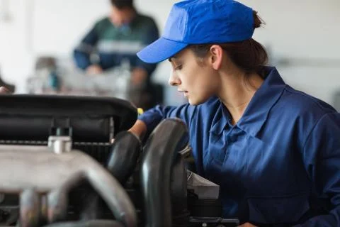 Focused trainee checking machine Stock Photos