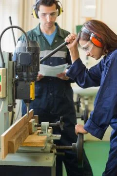 Focused trainee using drill Photos