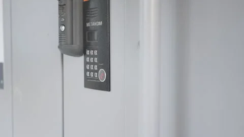 Focused view of intercom on door highlights modern features Video stock 306412848